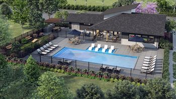 an aerial view of a swimming pool in a backyard with a patio and chairs